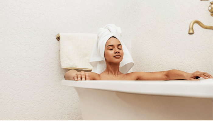 Woman taking a warm bath as part of her bedtime beauty routine